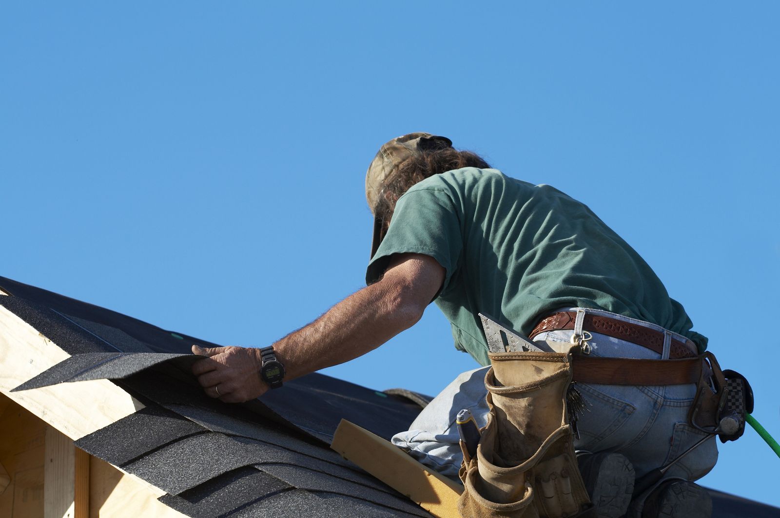 Roofer fastening architectural shingles on Dana's roof in Naperville