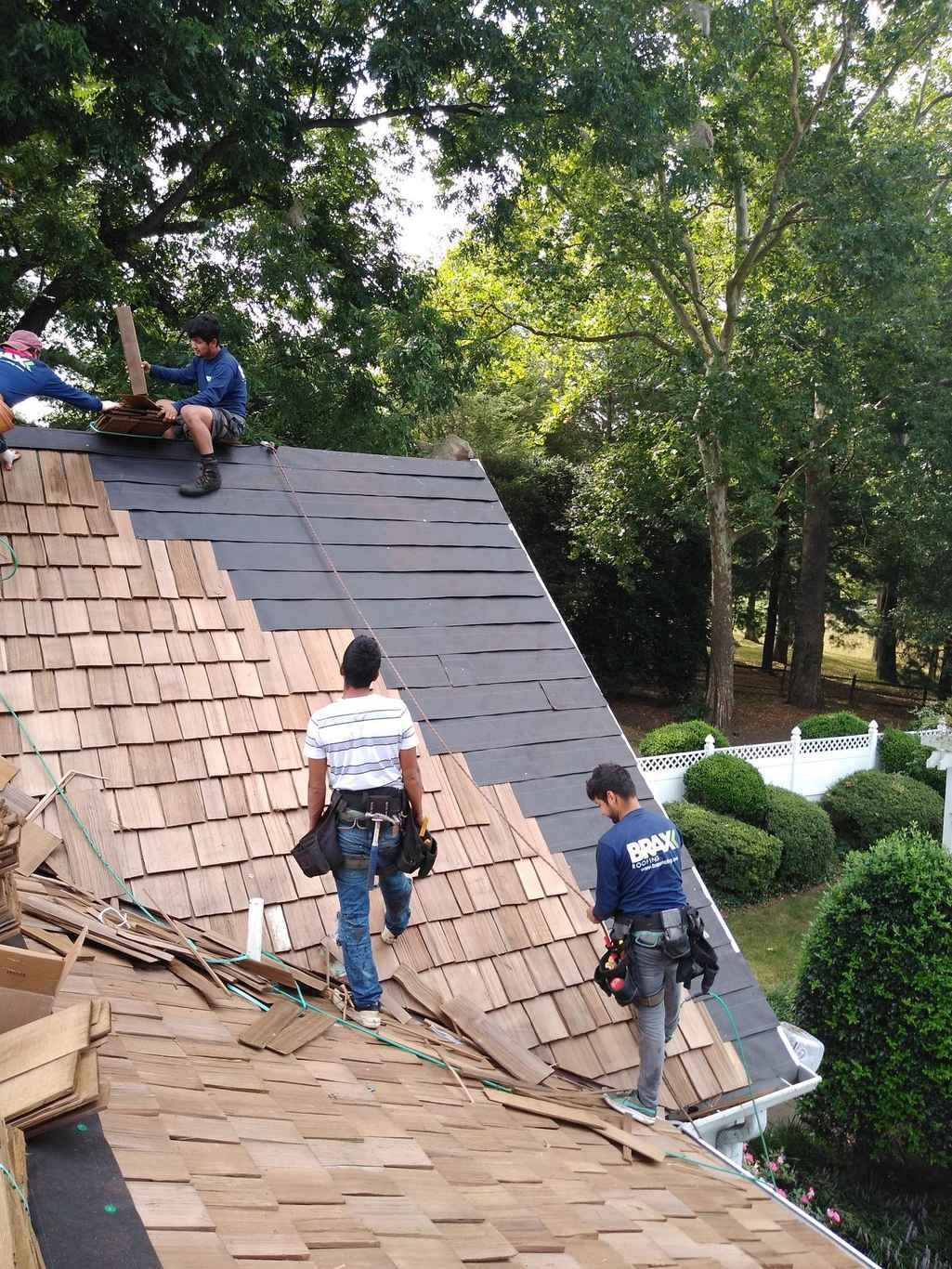 Two roofers on a steep pitched roof in Wheaton