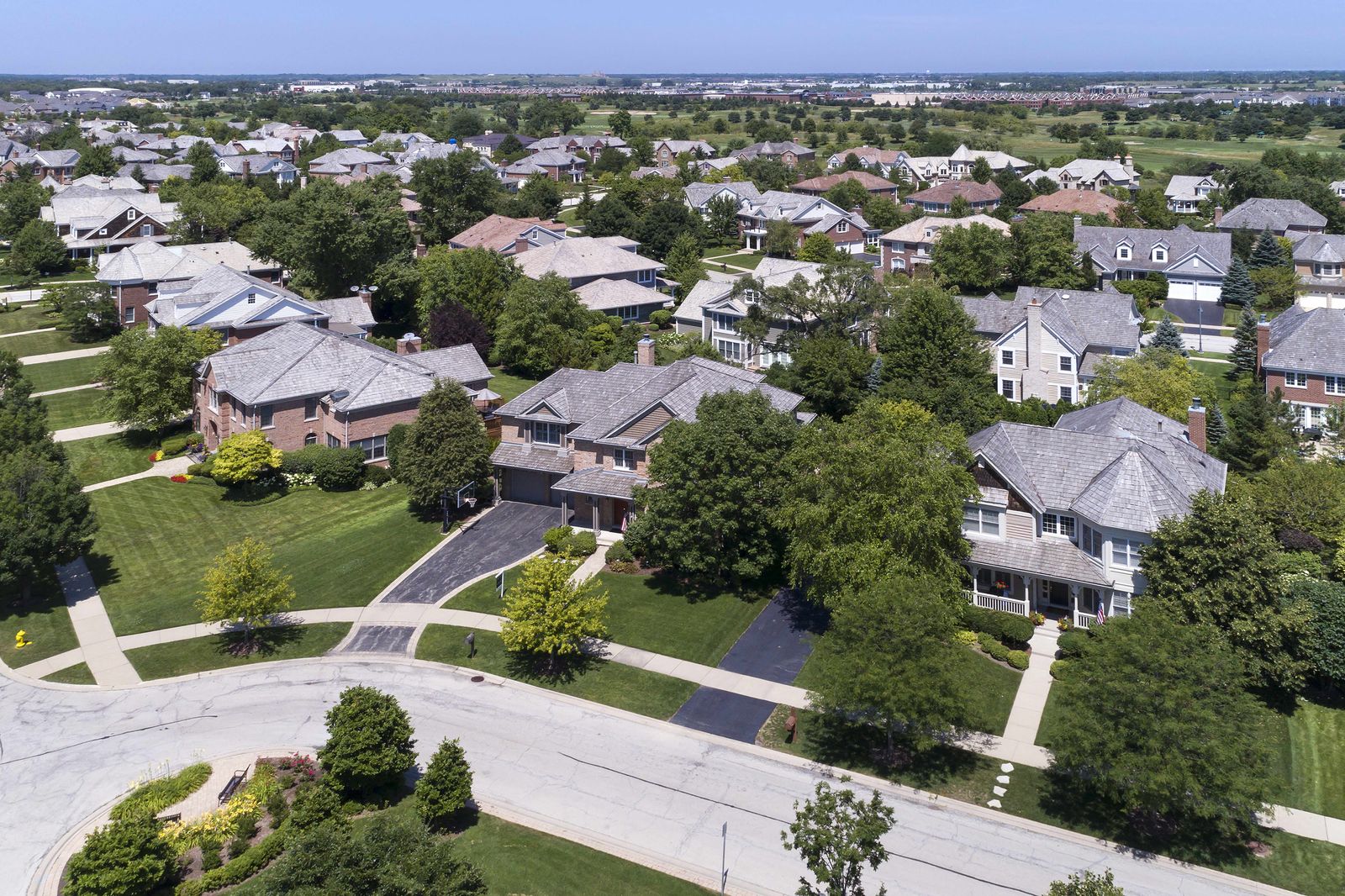 Aerial view of a block of single-family homes with new shingle roofs in Naperville